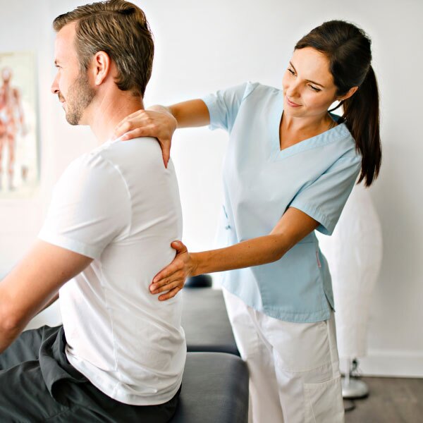 Patient with back pain and a Petts Wood and Chislehurst chiropractor is helping