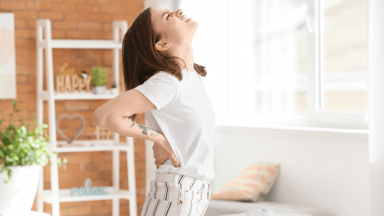 woman with lower back pain struggling