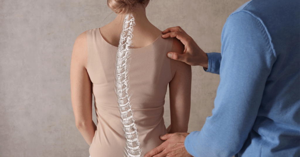 Chiropractor assessing a persons spine in a new patient consultation