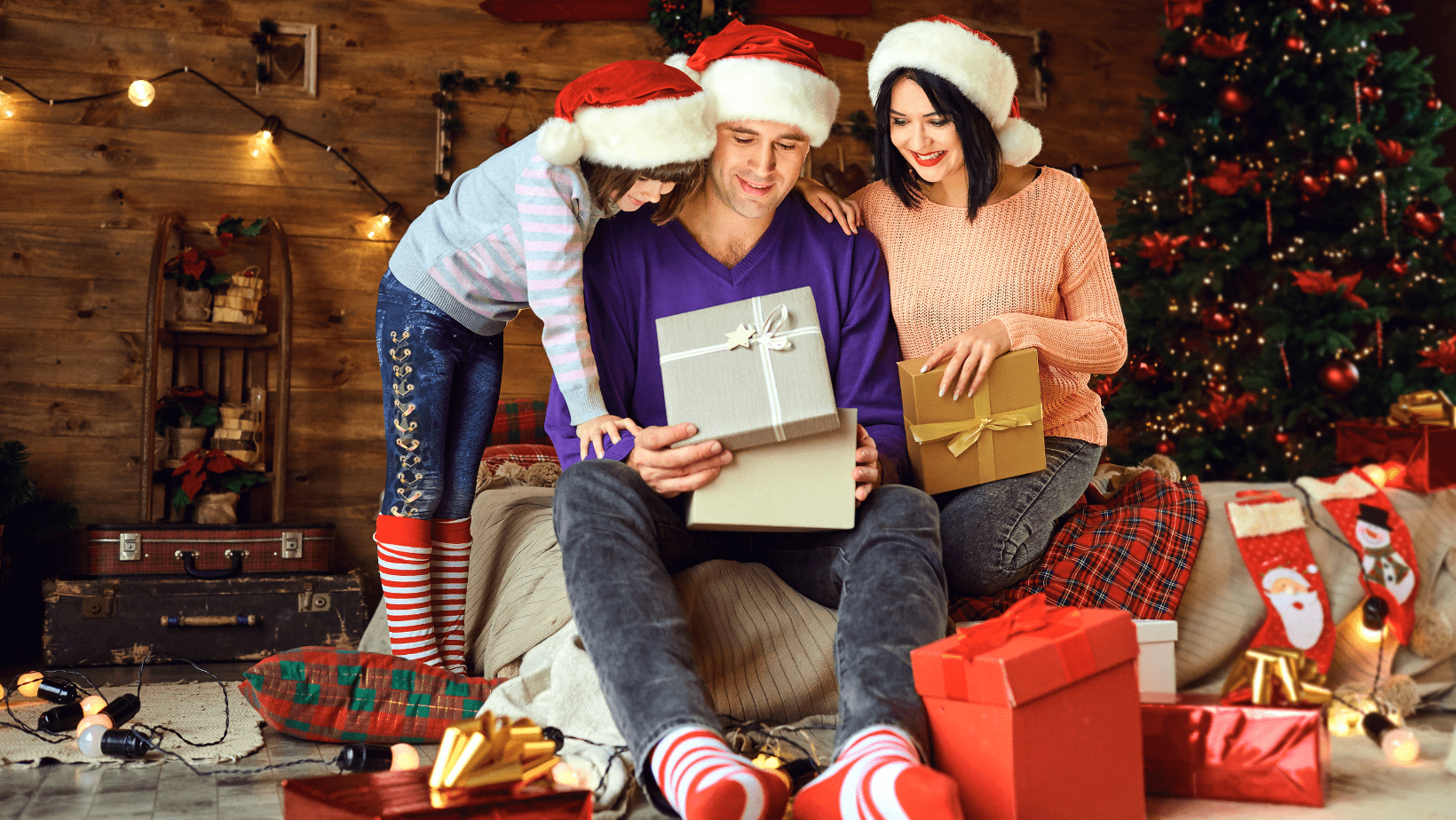 mum dad and son opening presents before seeing a chiropractor thats open over Christmas
