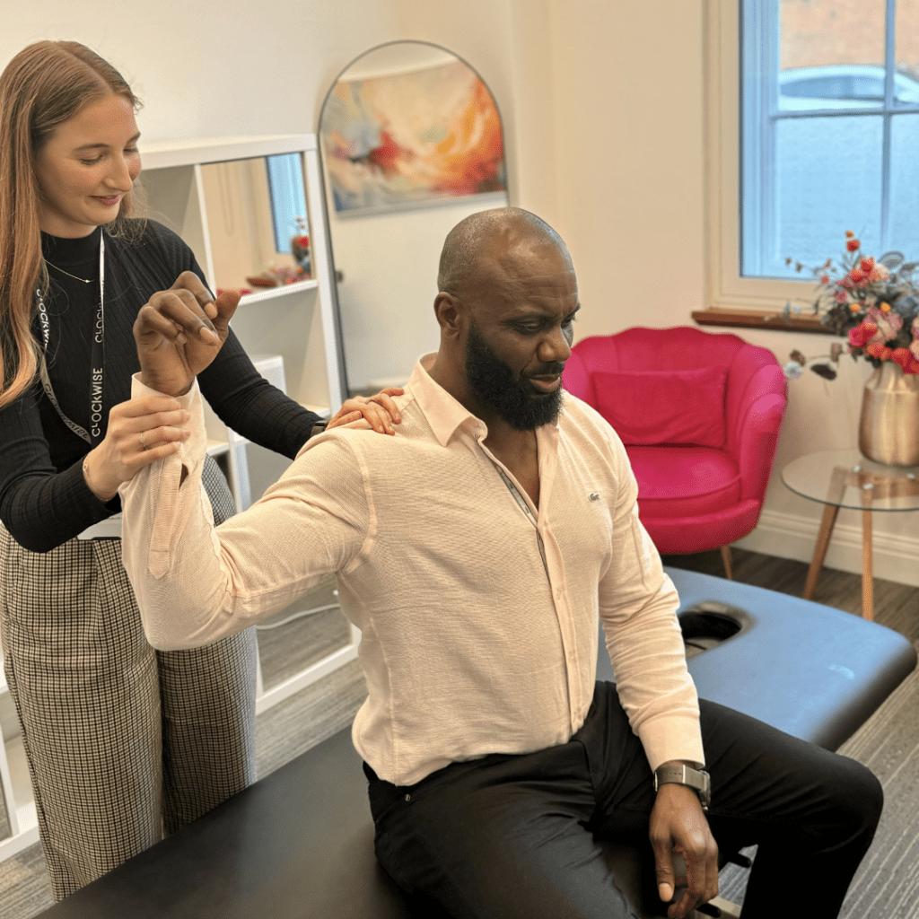 Chiropractor guiding a patient’s arm and shoulder during a treatment session at Back Care Chiropractic, Petts Wood
